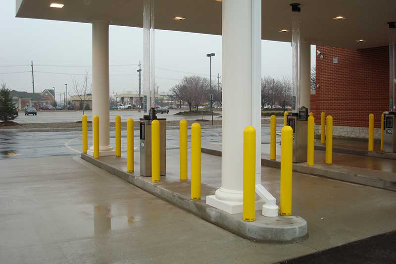 Bank drive thru protected with yellow bollard covers