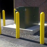 Electrical box guarded by heavy duty bollard covers in yellow