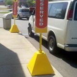 Yellow plastic Pyramid Sign Base with wheels used for McDonald's reserved parking spots