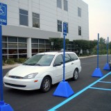 Blue plastic Pyramid Sign Base with wheels used for handicap accessible parking