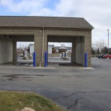 Blue Bollard Covers over Steel Pipe Bollards for car wash drive thru protection