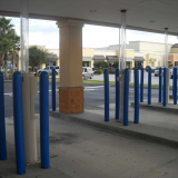 Blue plastic Bollard Covers guarding bank drive-thru lanes