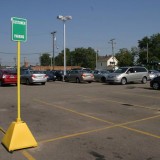 Yellow plastic Pyramid Sign Base with wheels used for designated customer parking