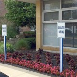 Blue and white U-Channel covers for designation parking spots