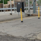 Yellow delineator posts lining facility entrance/exit gates