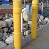 Yellow plastic Architectural Decorative Bollard Covers protecting gate entrance