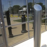 Storefront protection provided by black decorative bollard
