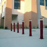 Dark red Light Bollard Covers providing safety at a local university
