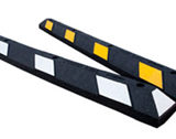 Black and yellow rubber parking stops