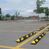 Black and yellow rubber parking stops