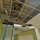 ceiling tiles removed to reveal fire suppression system burst pipe